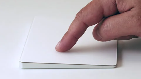 Gently Touching and Interacting with Sleek White Trackpad Device Stock Footage 312887735