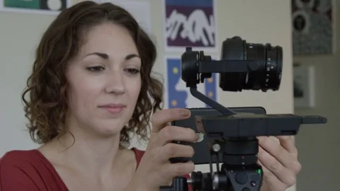 Genuine Female Engineering Programming A Robotic Camera Arm Remotely In Slow Stock Footage 82557911