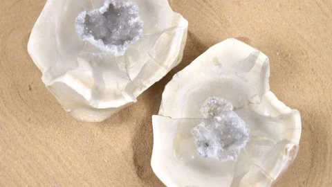 Geode rock crystal is rotating against the sand background Video stock 203891748