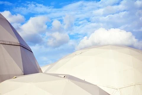 Geodesic dome on a background of blue sky 스톡 사진