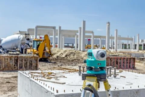 Geodesist device on tripod is connected with total station on a building site Stock Photos