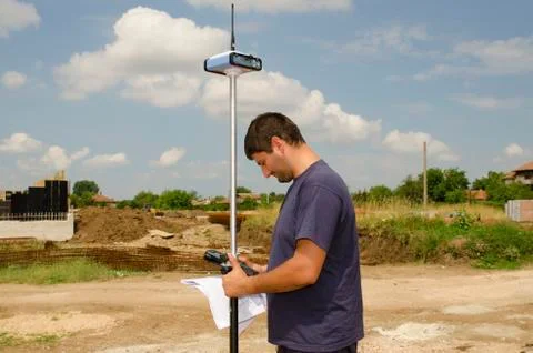 Geodesist working on a terrain Stock Photos