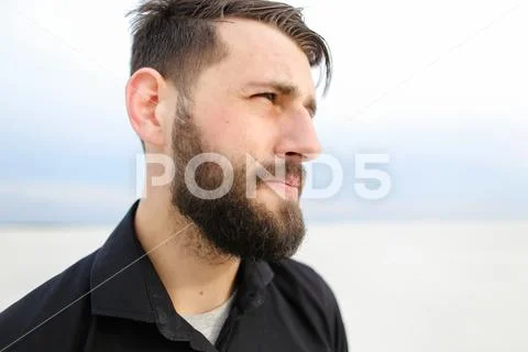 Geographer male smoking carrying out research on seaside. Stock Photos