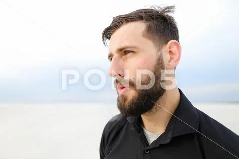 Geographer male smoking carrying out research on seaside. Stock Photos