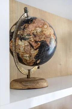 Geographical globe on the shelf Stock Photos