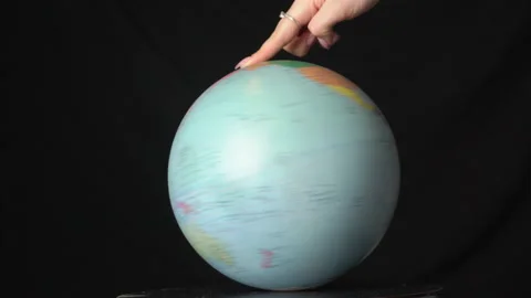 Geographical Globe is Twisted Around its Axis by a Female Hand Stock Footage 170942661