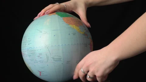 Geographical Globe is Twisted Around its Axis by a Female Hand Stock Footage 170942888