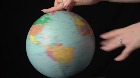 Geographical Globe is Twisted Around its Axis by a Female Hand Stock Footage 170943229