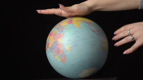 Geographical Globe is Twisted Around its Axis by a Female Hand Stock Footage 170945650