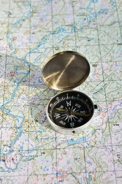 Geographical map and a compass. Stock Photos