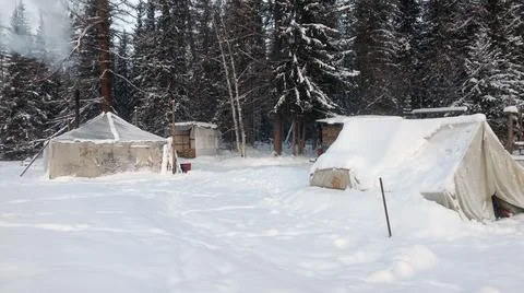 Geological field camp in the winter in the forest. Old tents Stock Photos