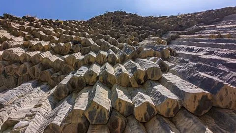 Geological hexagonal rock pattern with sharp edges and natural color variations Stock Photos