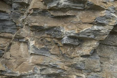 Geological layers of a rough structured stone in a  full frame image Stock Photos