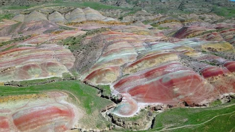 Geological pattern with maroon, yellow and white stripes among the mountains Stock Footage 278612210