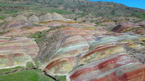 Geological pattern with maroon, yellow and white stripes among the mountains Stock Footage 278612264