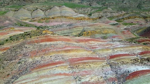 Geological pattern with maroon, yellow and white stripes among the mountains Stock Footage 278612287