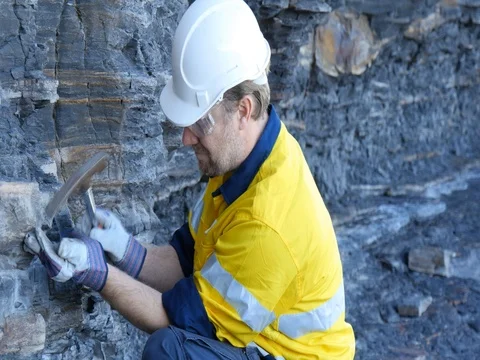 Geologist engineer man examines sedimentary layer mineralogy Industry Video stock 78587622