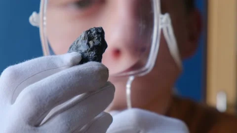 Geologist examines a rock sample with a magnifying glass 動画素材 151216190
