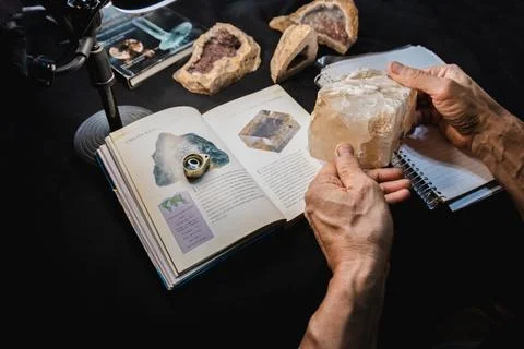 Geologist learning about Blue Calcite. Stock Photos