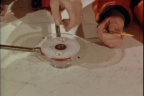 Geologist plot results on chart and officer looks through telescope - 1966 Stock Footage 103604928
