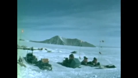 Geologists from Birdland Camp travel by motor toboggan to sample exposed rocks Stock Footage