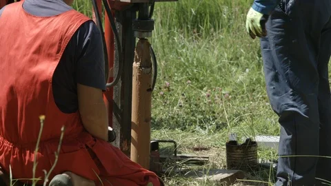 Geologists using drill rig to get geological core samples from borehole Video stock 123671588