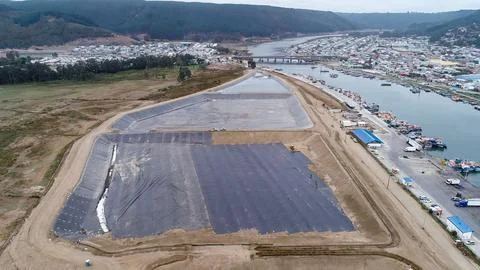 Geomembrane deployment and installation process with machinery in the const.. Stock Photos