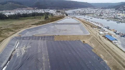 Geomembrane deployment and installation process with machinery in the const.. Stock Photos