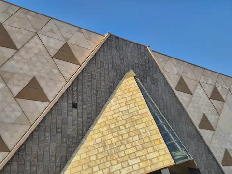 Geometric architectural facade with triangular glass and tiled patterns Stock Photos