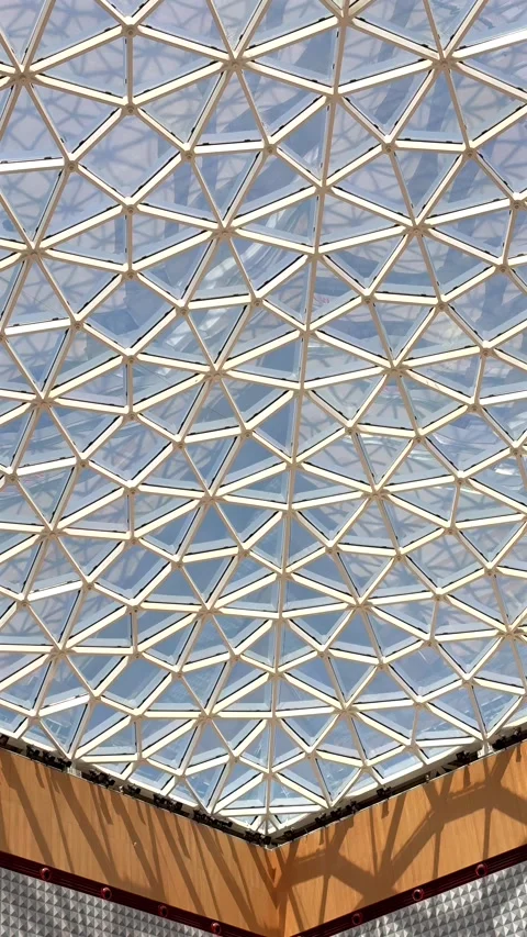 Geometric ceiling structure with triangular glass design showcasing innovative Stock Footage 284854580