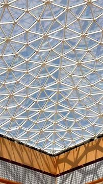 Geometric ceiling structure with triangular glass design showcasing innovative Stock Photos