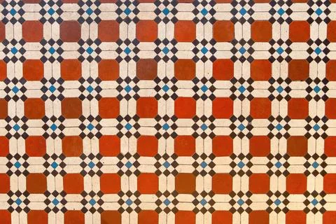 Geometric ceramic tile floor with repeating square and diamond pattern Stock Photos