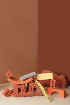 Geometric composition of bricks, glass bottle and plants. In a corner space of Stockfoto's
