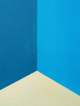 Geometric corner intersection with blue and beige textured walls Stock Photos