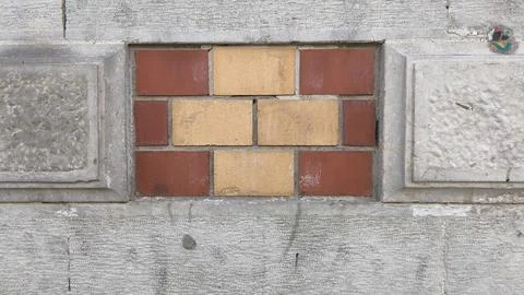 Geometric decorative tile pattern on a stone wall. Stock Photos