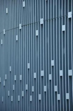 Geometric facade with vertical lines and rectangular cutouts 스톡 사진