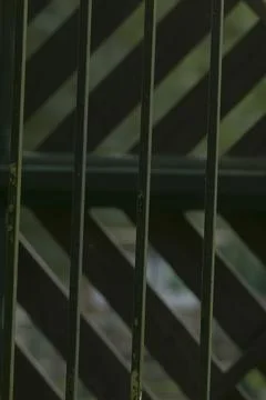 Geometric fence elements emphasizing rhythm and shadow play in architecture Stock Photos