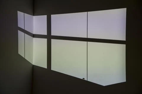Geometric flat pane shape projected on wall by projector 스톡 사진