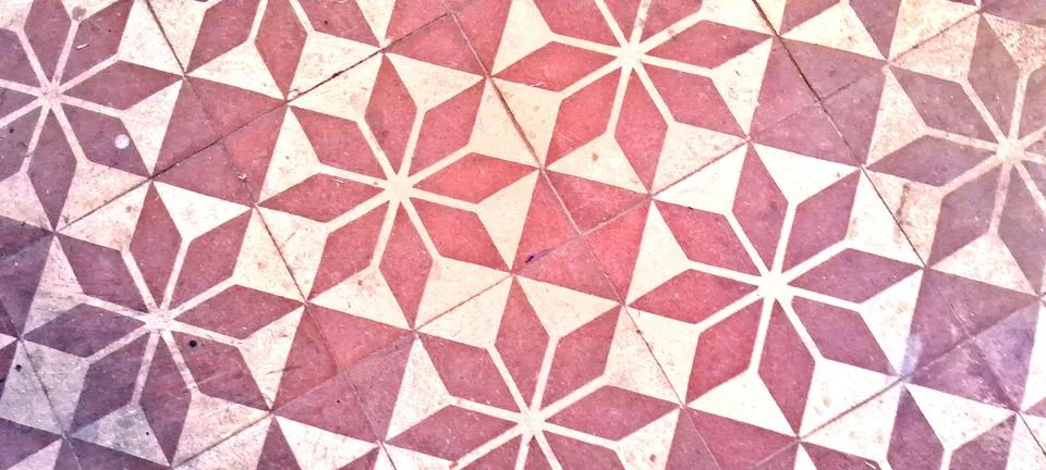 Geometric floor tiles featuring repeating star patterns in warm tones Stock Photos