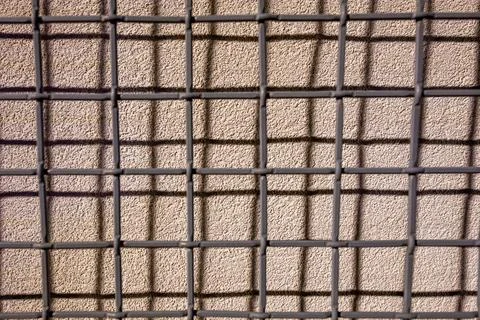 Geometric Grid Pattern on Textured Wall Stock Photos