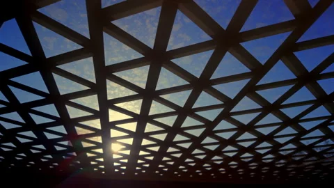 Geometric grid roof with triangular pattern against bright blue sky and sun.. Stock Footage 314607903