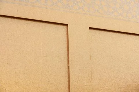 Geometric Islamic patterns are etched into the gold mosaic tile exterior Fotos Stock