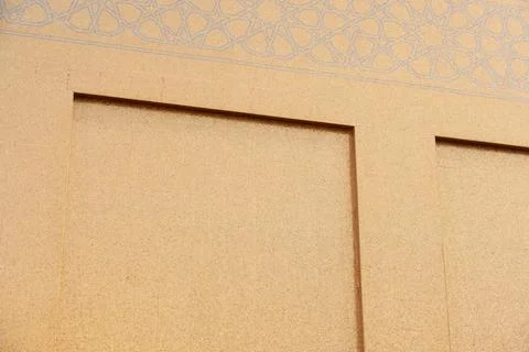 Geometric Islamic patterns are etched into the gold mosaic tile exterior  Fotos de archivo
