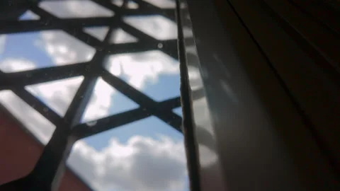 Geometric metal lattice casting sharp silhouette against bright sky with so.. Stock Footage 314607963