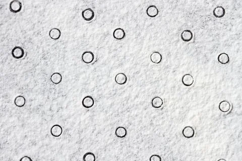 Geometric ornament with dots pattern from white flour sand, powder on table.  Stock Photos