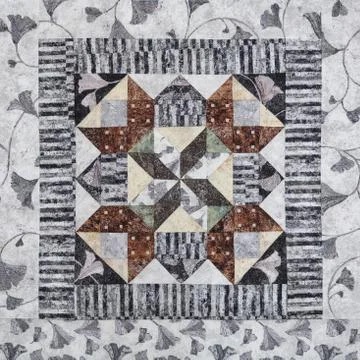 Geometric patchwork block from pieces of fabrics, detail of quilt Stock Photos