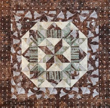 Geometric patchwork block from pieces of fabrics, detail of quilt 库存照片