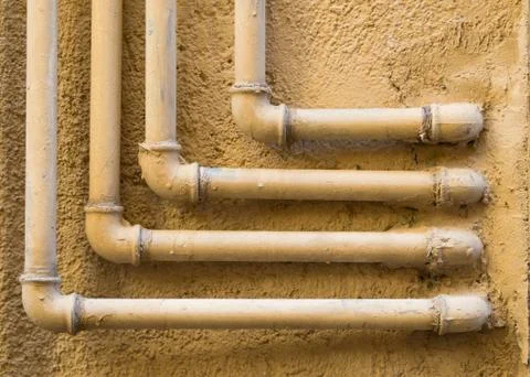 Geometric pattern of 90 degree water pipes and fittings Stock Photos