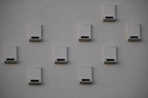 Geometric Pattern of Bird Nest Boxes on Modern Exterior Wall Stock Photos