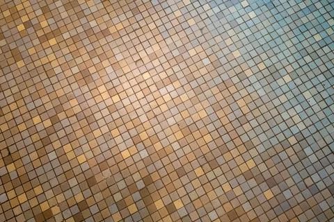 Geometric pattern of brown and beige mosaic tile floor 스톡 사진